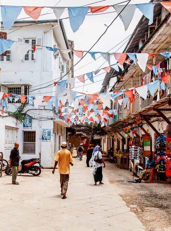 Local people on a street in Stone Town. Stone Town is the old part of Zanzibar City, the capital of Zanzibar, Tanzania