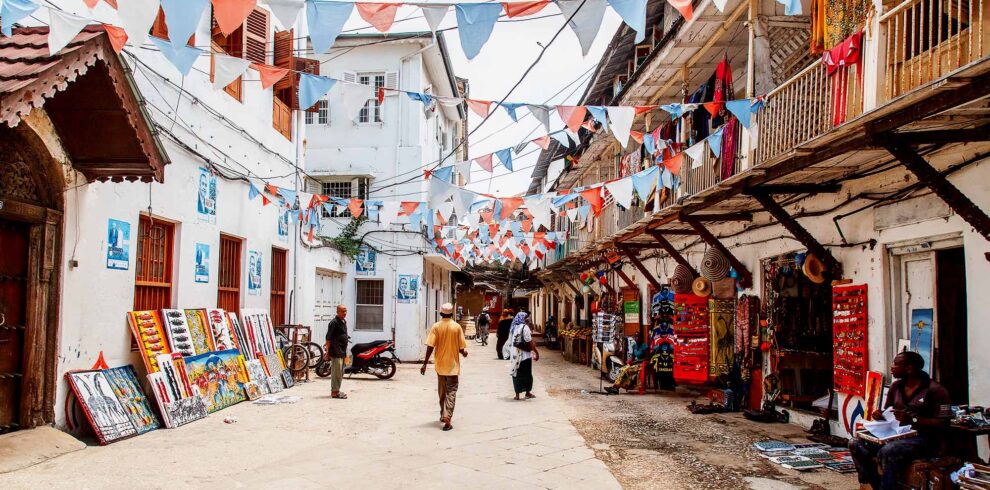 Local people on a street in Stone Town. Stone Town is the old part of Zanzibar City, the capital of Zanzibar, Tanzania